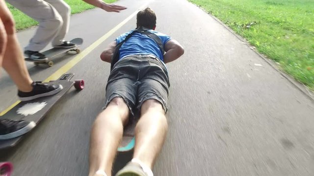 Cool guy longboarding lying down