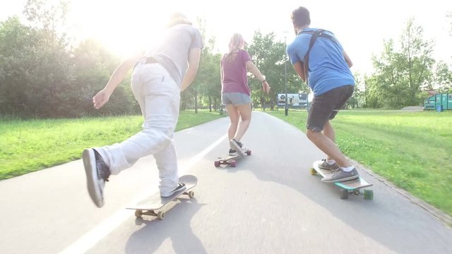 Back view of young people skateboarding