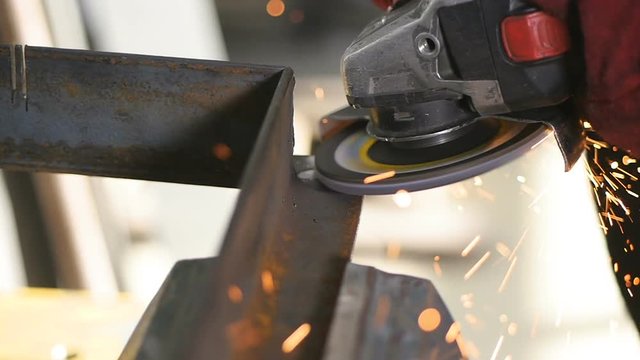 Sparks is thrown from an angle grinder in the camera direction. SLOW MOTION. HD.