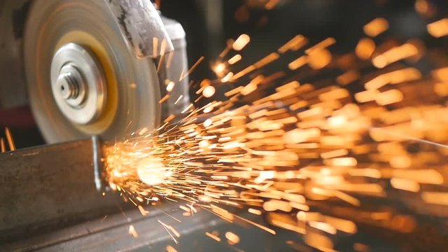 Sparks from grinder flies in to the camera. SLOW MOTION. Grinder circle - close-up. HD.