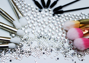 Brushes for make-up and precious stones.