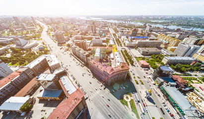 Aerial city view with crossroads, roads, houses, buildings, parks and parking lots. Copter drone helicopter shot. Panoramic wide angle image.