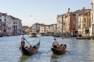 Fototapeta na wymiar Two gondolas near the Palazzo Michiel dalle Colonne, a palace in Venice, Italy, located in the Cannaregio district and overlooking the Grand Canal