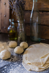 Pizza dough on rustic background