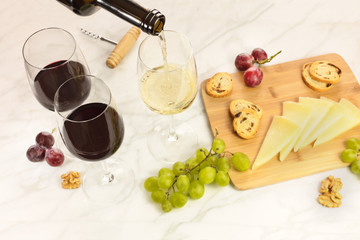 Red wine, cheese, bread and grapes at tasting