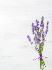 Few sprigs of lavender on  wooden background.