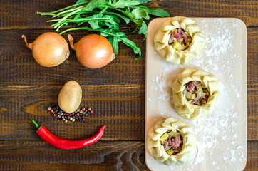 A national Uzbek dish - balish with meat, onion, red pepper, potatoes and herbs in the form of a smile