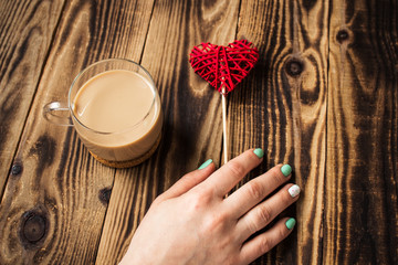 Woman hand bright manicure cup of coffee handmade heart