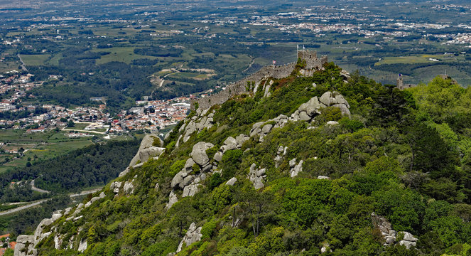 View from Palacio Pena of the adjacent ruins of the Castle of the Moors, standing on a mountaintop above the popular town of Sintra, Portugal