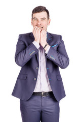 business man biting his nails fingers freaking out. human emotion expression and lifestyle concept. image on a white studio background..