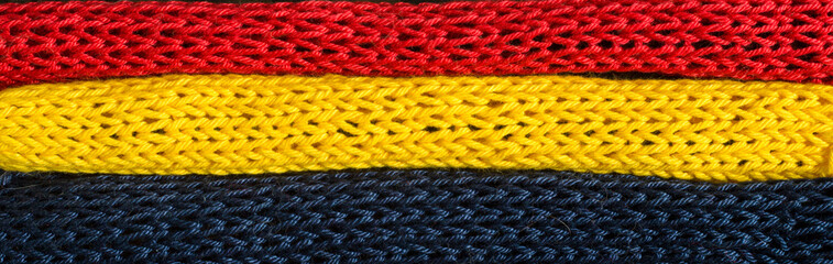 Knitted fragments of the flag colors: red, blue, yellow