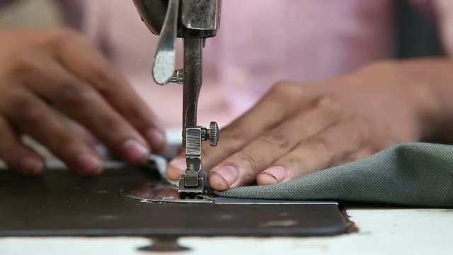 Man working on a sewing machine.