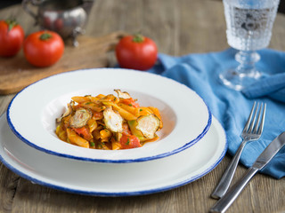 White plate with pasta and vegetables