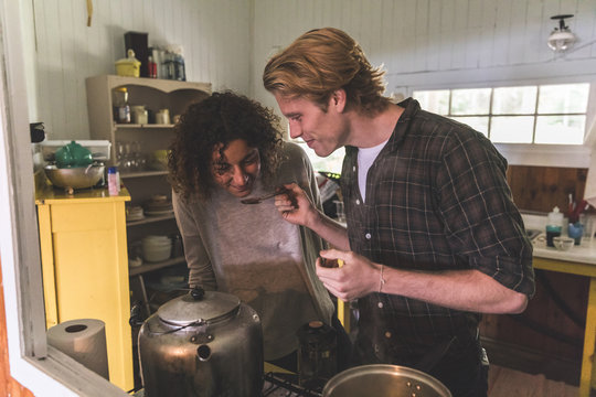 Couple Cooking Together In A Cabin