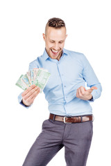 portrait of young businessman holding and counts money dollar bills in hands, isolated on white background. emotion facial expression feeling. financial reward savings