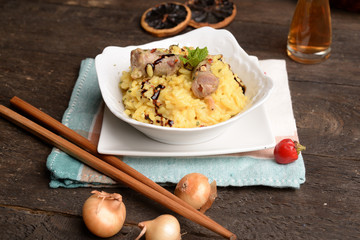 Bowl of saffron rice with sausage and wine