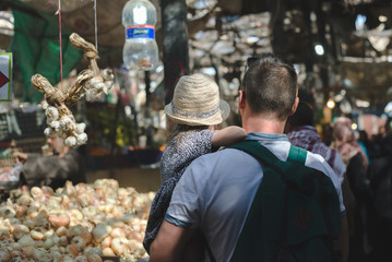 European family in the local Arabic food market. Dad and daughter are shopping on the east market