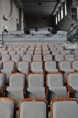 Rows of gray soft seats in empty cinema hall