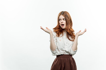 surprised woman holding her hands up against a light background