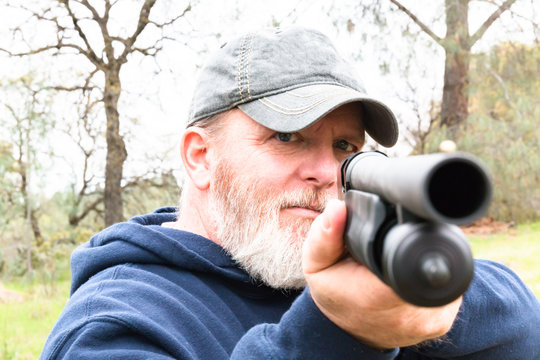 Man With Beard Aiming Shotgun