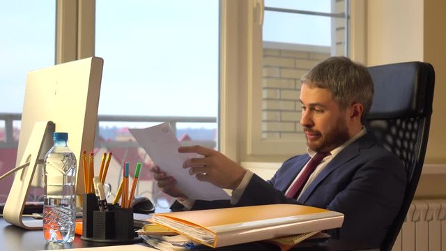 Frustrated businessman torning apart the document. 4K video