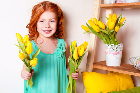 Redhead girl with yellow tulips. Easter card. Happy Easter