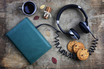 audiobook headphones and book on wooden table