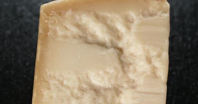 closeup pan of parmesan cheese on slate board, 4k prores footage