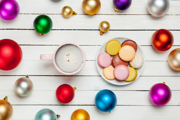 Naklejka na ściany i meble photo of cup of coffee and plate full of macaroons on the wonderful white wooden background