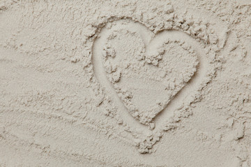 photo of heart shaped drawing on the sand on the beach