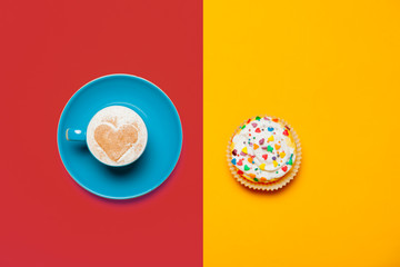 photo of cup of coffee and cupcake on the wonderful  colorful background in pop art style