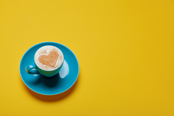 photo of cup of coffee on the wonderful yellow background