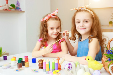 Fototapeta premium Two girls painting Easter eggs