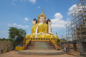 Big golden Buddha against blue sky