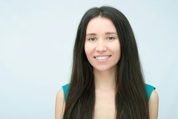 Young positive brunette girl with long hair wearing