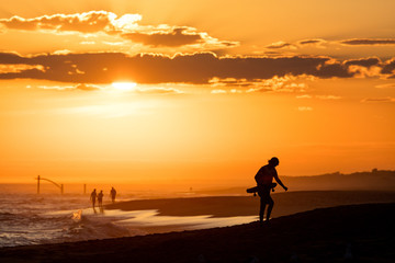 Fototapeta na wymiar Skateboarder at beach during Sunset