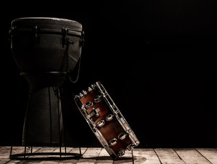 Fototapeta na wymiar musical percussion instruments on black background drum Bongo and snare