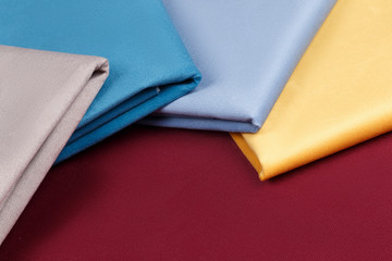 Fabric neatly folded, laid out with different patterns for design