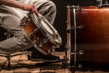 Fototapeta na wymiar man adjusts percussion instruments, creative music concept