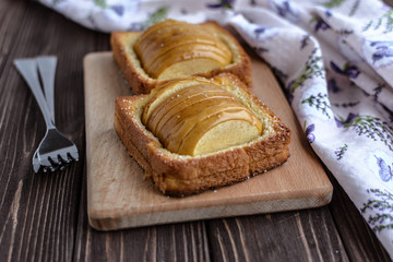 Baked apples with toast on a rustic background