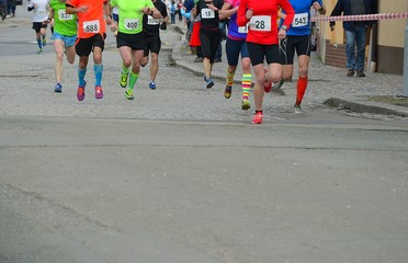 Runners running race through the town. Running concept.