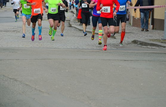 Runners running race through the town. Running concept.