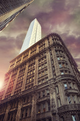 Fototapeta na wymiar Tall skyscrapers in New York city, cloudy sky in background.