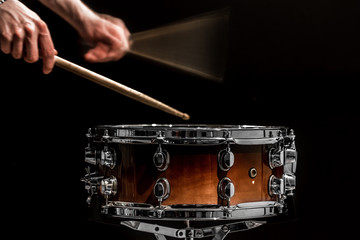 man plays musical percussion instrument with sticks a musical concept with the working drum