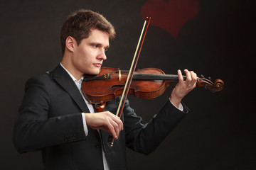 Man man dressed elegantly playing violin