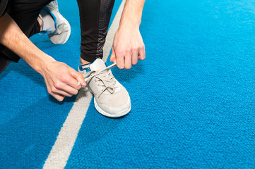 healthy lifestyle sports men tying shoelace