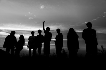 Fototapeta na wymiar Silhouette of a group of people at sunset,black and white
