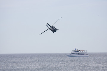 Naklejka premium Helicopeters hovering over ship