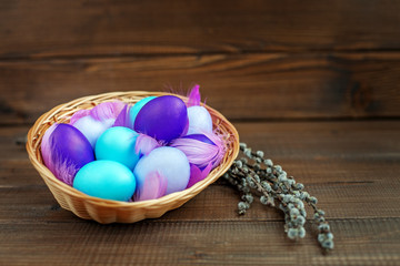 Eggs in a basket on a wooden background. Concept Happy Easter.