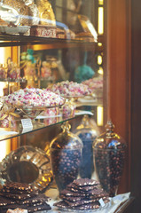 Rich variety of chocolates and candies in display window  of italian pastry shop
